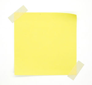 Close-up of yellow paper against white background