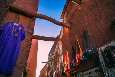 Low angle view of clothes drying against sky