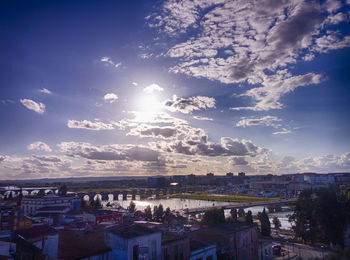 Buildings against cloudy sky