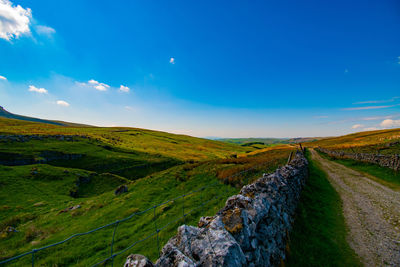 Scenic view of landscape against blue sky