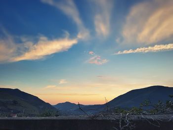 Scenic view of silhouette mountains against sky at sunset