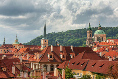 Lesser town rooftops and buildings with storm clouds on sky. the medieval settlement of prague.