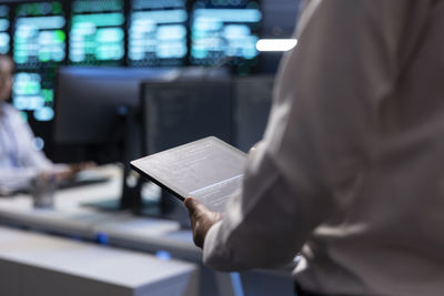 Midsection of man working in office