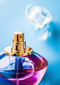 Close-up of glass bottle against blue background