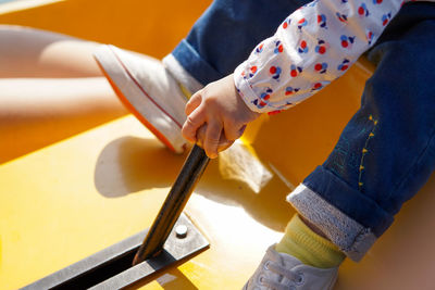 Low section of child holding gearshift in boat