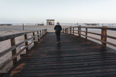 Pier over sea against clear sky