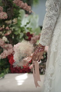 Close-up of woman holding flower bouquet