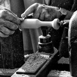 Man carving wood at workshop