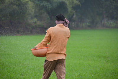 Rear view of man standing on field