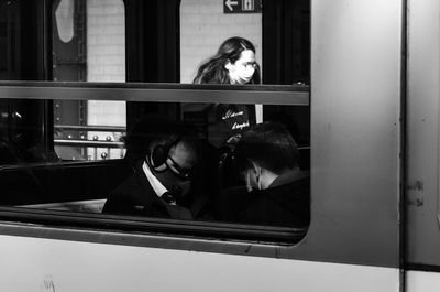 Portrait of woman looking through window