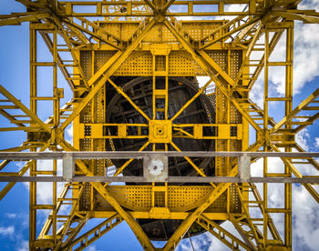 Low angle view of crane against sky