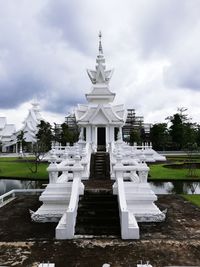 View of white building against cloudy sky