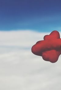 Low angle view of person hand against sky