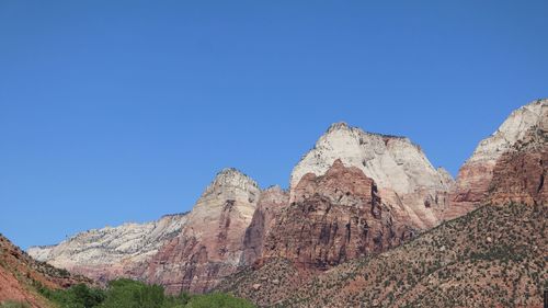 Scenic view of mountains against clear blue sky