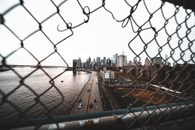 Cityscape seen through chainlink fence