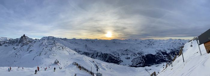 Snow covered mountains against sky during sunset