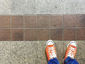 Low section of man standing on footpath