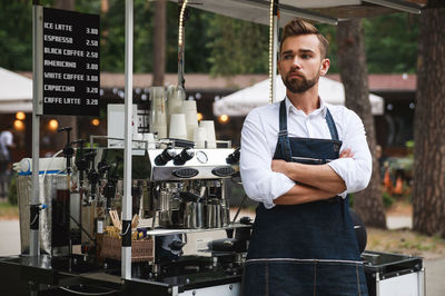 Portrait of young man standing in factory