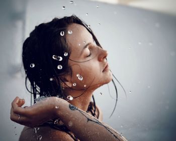 Close-up portrait of wet girl in bathroom