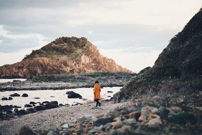 Rear view of woman looking at sea against sky