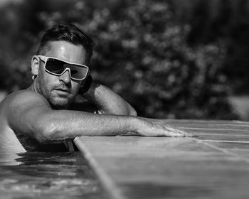 Portrait of man wearing sunglasses at swimming pool