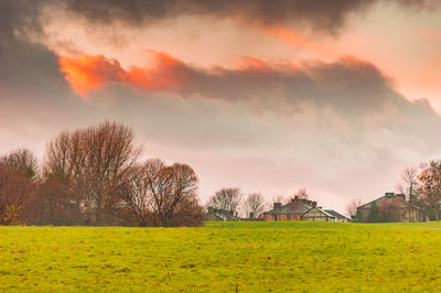 Scenic view of field against sky during sunset