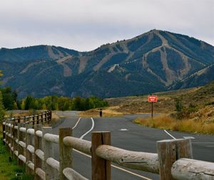 Empty road against mountains