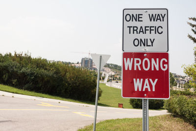 Low angle view of road sign against sky