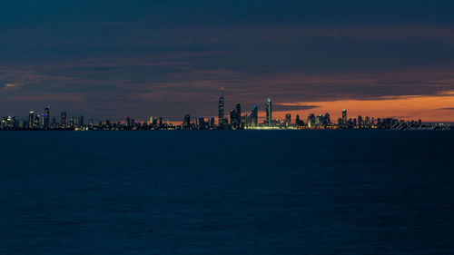 City at waterfront during sunset