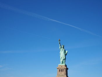 Statue of liberty against blue sky