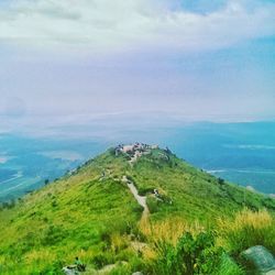 Scenic view of green landscape against sky