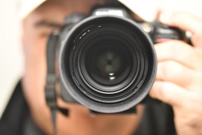 Close-up of man photographing camera