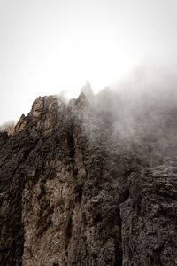 Low angle view of rock formations against sky