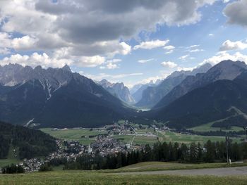 Scenic view of field and mountains against sky