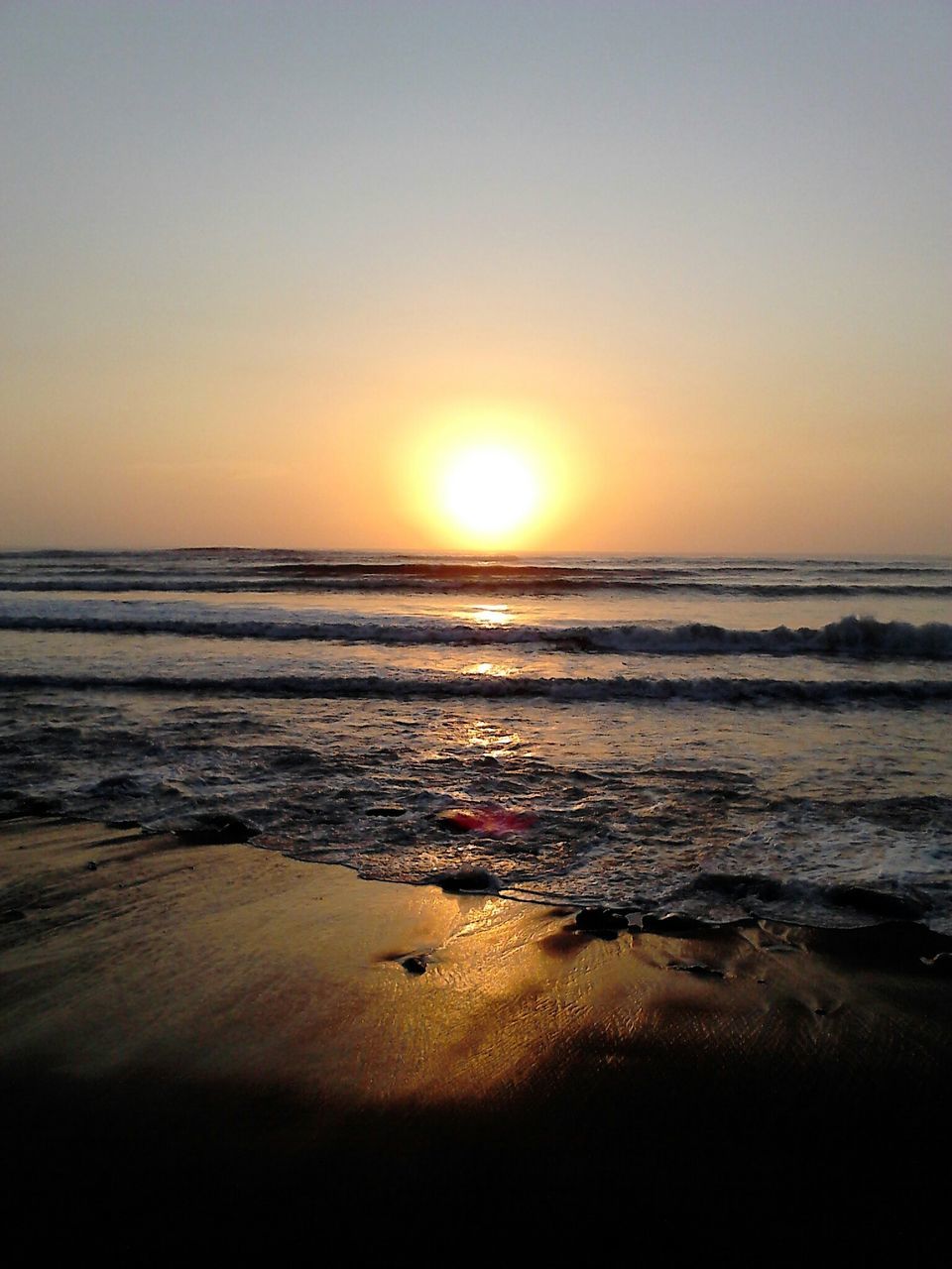 sea, horizon over water, sunset, beach, water, scenics, shore, sun, tranquil scene, beauty in nature, tranquility, wave, orange color, clear sky, idyllic, nature, copy space, sky, sand, sunlight