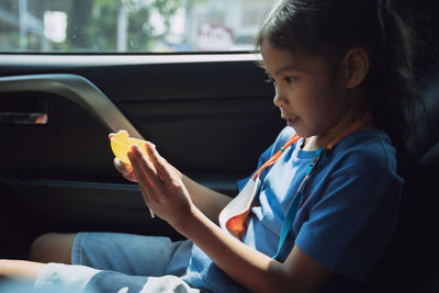 Cute girl sitting in car