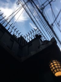 Low angle view of electricity pylon against sky