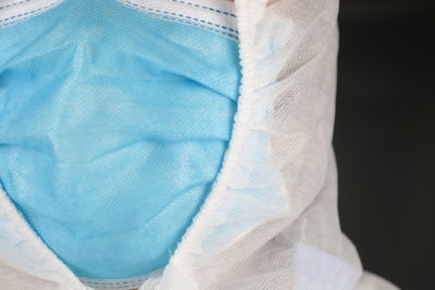 Close-up of blue hat against black background