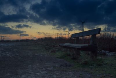 Wind turbines on field at sunset