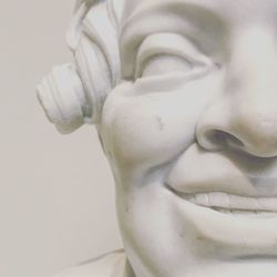 Close-up of statue over white background
