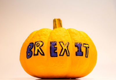 Close-up of pumpkin against yellow background