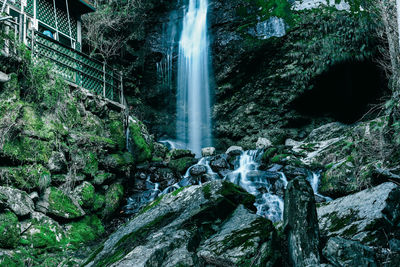 Low angle view of waterfall from cliff