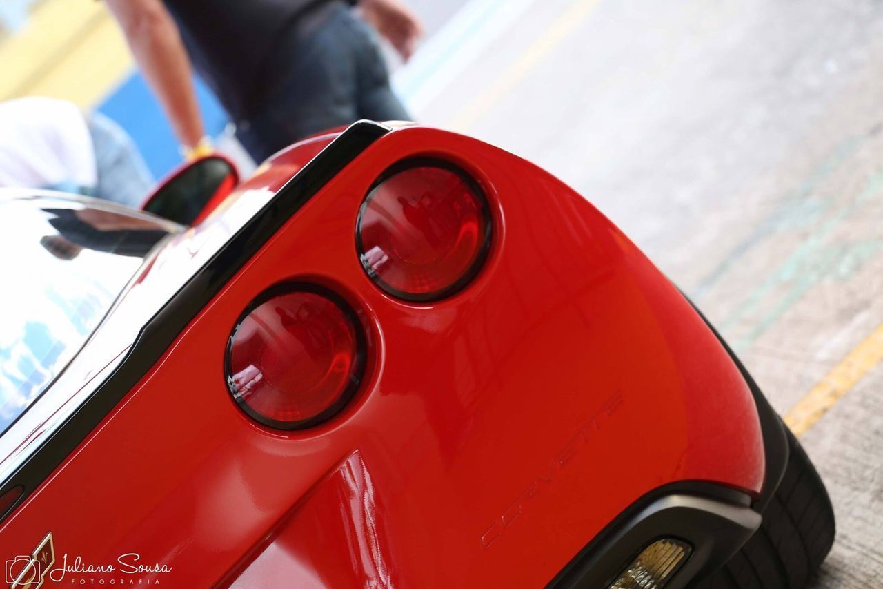 CLOSE-UP OF RED CAR ON SIDE-VIEW MIRROR