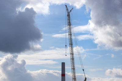 Low angle view of communications tower against sky