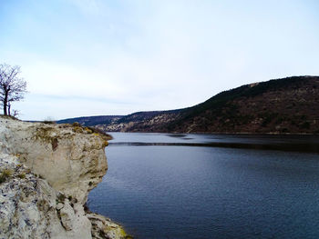 Scenic view of calm lake against mountain range