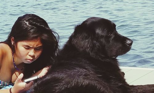 Close-up of woman with dog in water