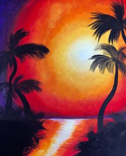 Silhouette palm tree against orange sky