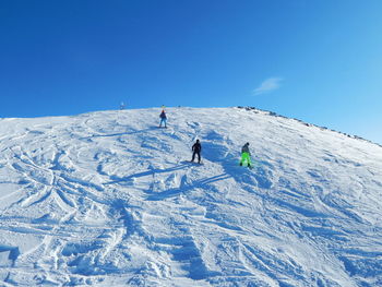 People on snowcapped mountain