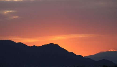 Scenic view of silhouette mountains against sky during sunset