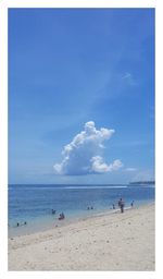 Scenic view of beach against blue sky